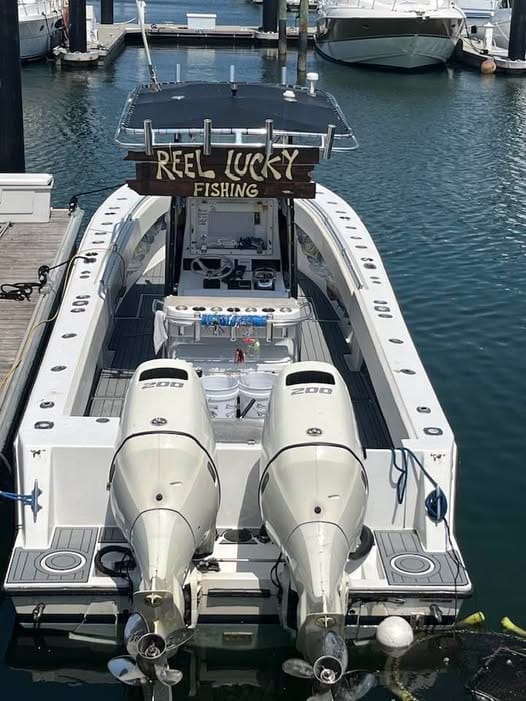 A sleek fishing boat named Reel Lucky on calm waters, ideal for private fishing charters West Palm Beach FL.