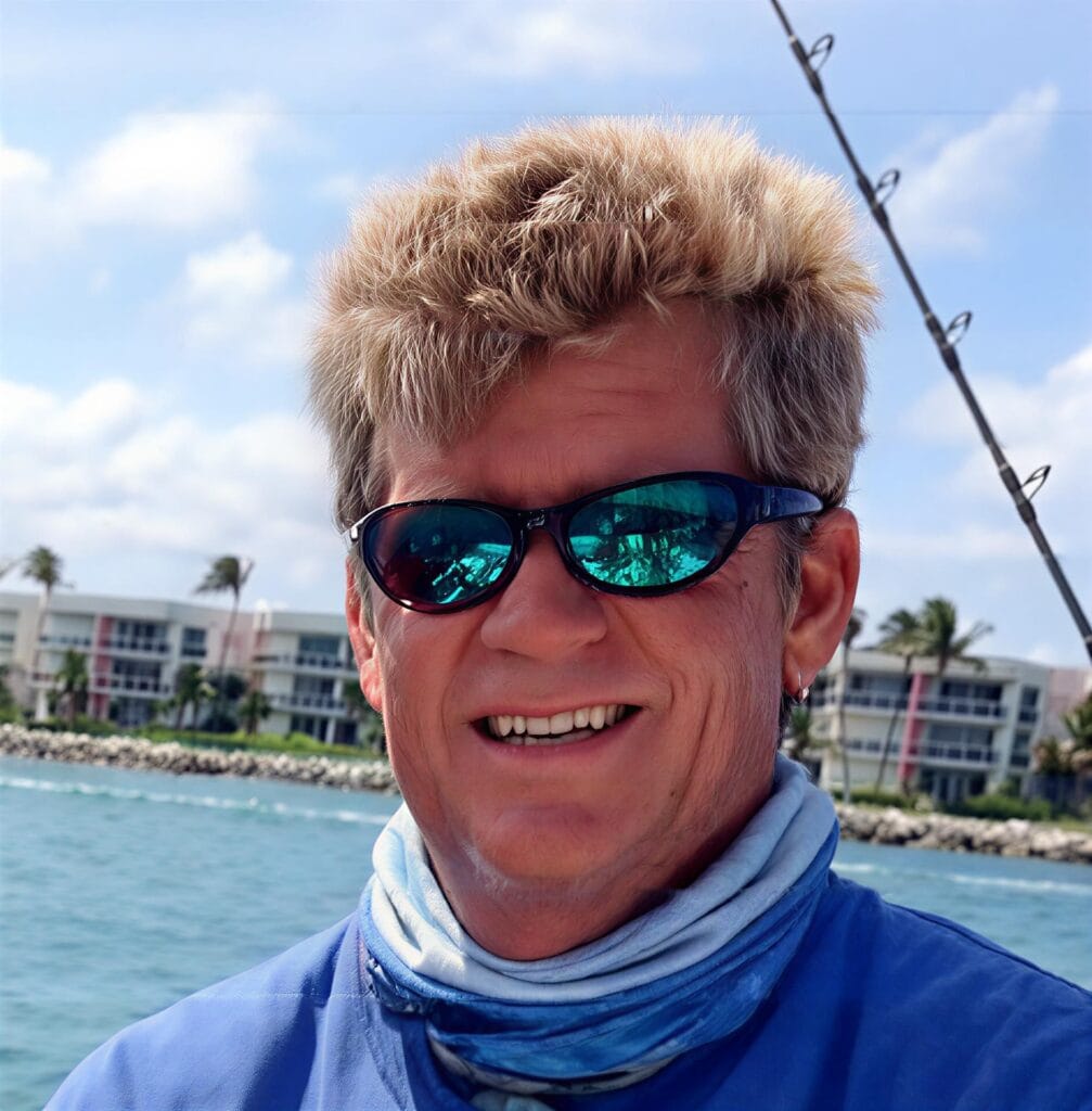 A man holding a large fish on a boat, showcasing a successful catch during private fishing charters West Palm Beach FL.